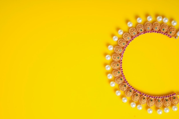 Premium Photo | Gold jewelry on yellow background