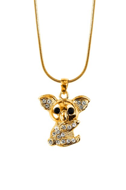 Photo gold koala shaped pendant with crystals hanging on a chain isolated over white