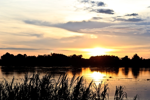 Gold light on sun set with light on the river.Idyllic Wallpaper Setting Sun.