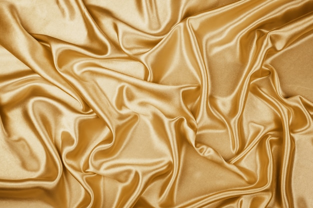 Gold luxury satin fabric texture for background