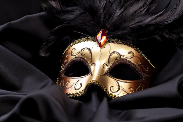 gold mask on black silk