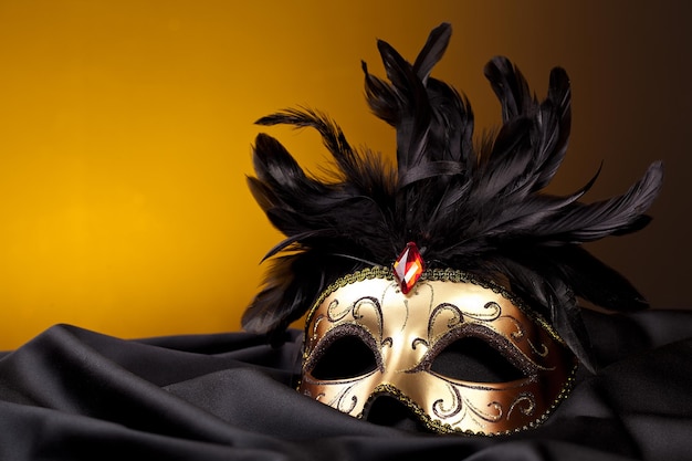 gold mask on black silk