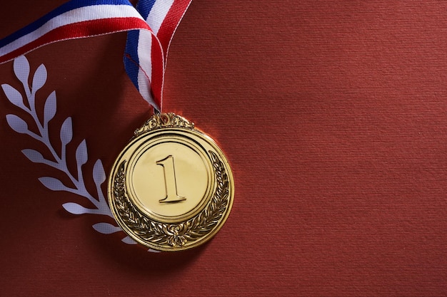 Gold medal against red background