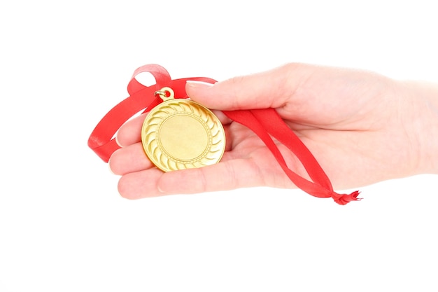 Photo gold medal in hand on white