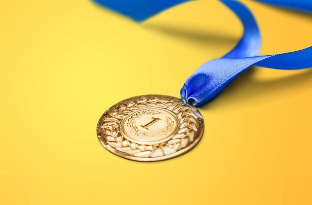 Gold medal with  ribbon  on  background