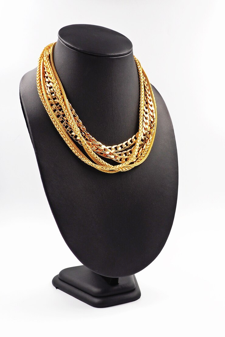Photo gold necklace on necklace display stand.
