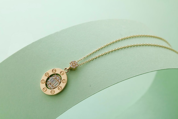 A gold necklace with a diamond in the center.