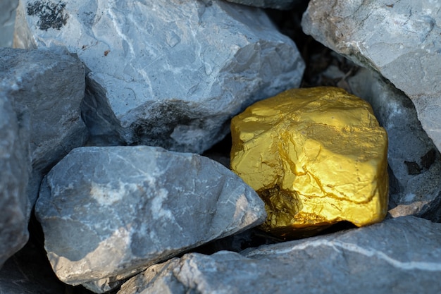 Gold nugget and grey granite stone background