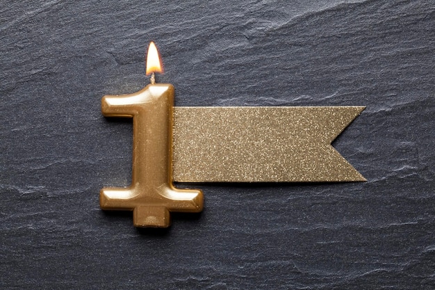 Gold number 1 celebration candle with glitter label