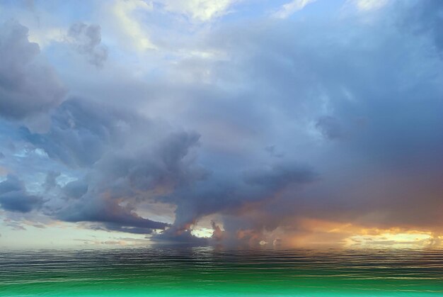 gold orange sunset dramatic cloudy sky at night and sea water wave reflection