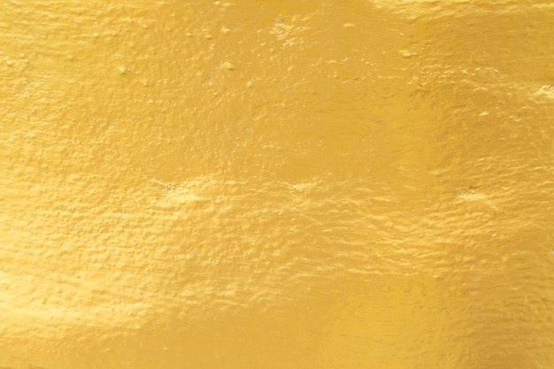 Gold paint on cement wall texture background