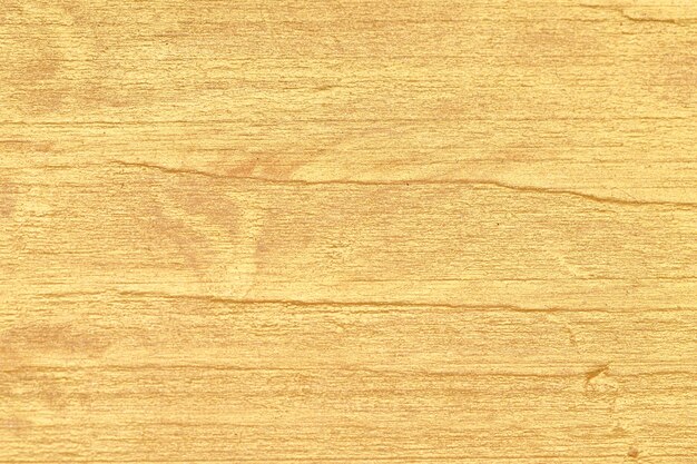 Gold paint on a wooden surface. background for design