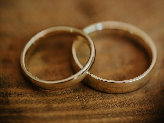 Gold pair of ring on wooden table