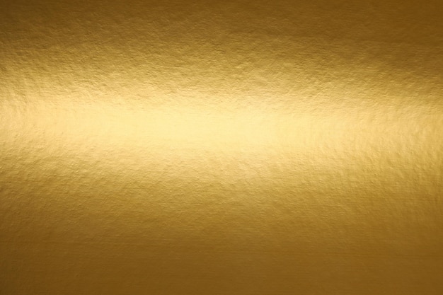 A gold paper with a light shining on it