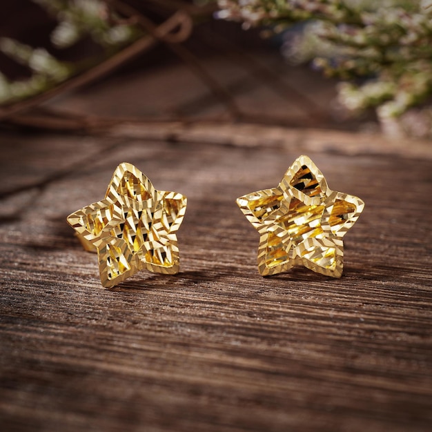 Gold Pierced Earrings on background wood