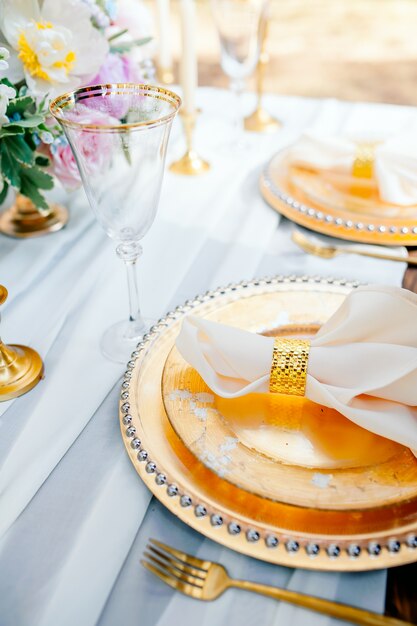 Gold place setting with empty menu on grunge