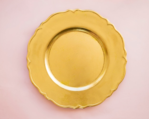 Photo gold plate on pink table