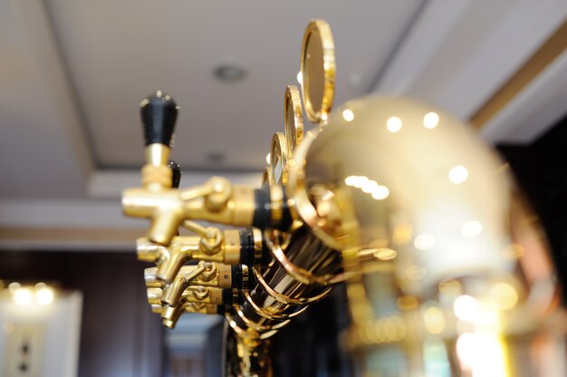 Gold plated beer tap for dispensing beer closeup