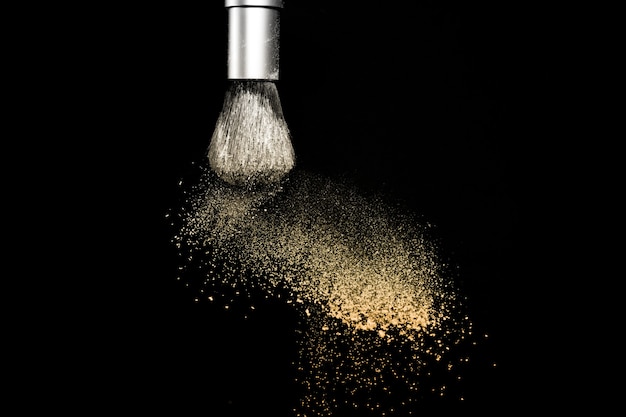 Photo gold powder explosion black background