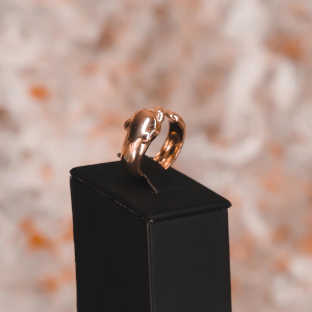 A gold ring on a black box