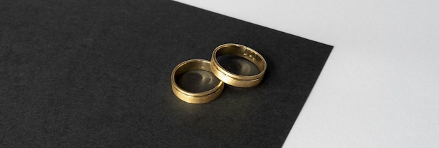 A gold ring on a black surface