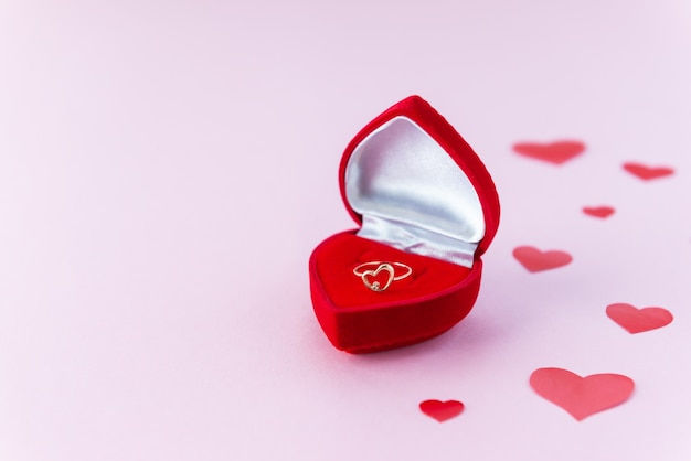 Gold ring in a box in the form of a heart.