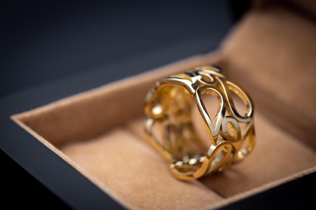 A gold ring in a box with a diamond ring in it