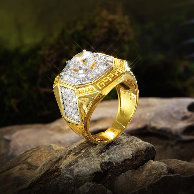 Gold ring men with diamonds, cubic Zirconia, emeralds, and precious stones on background rock moss