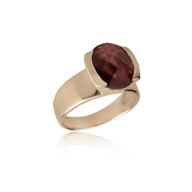 A gold ring with a garnet on the side.