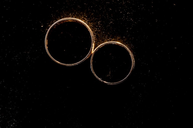 Gold rings on a black background