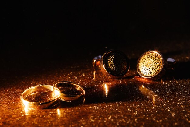 Gold rings and cufflinks on the table.