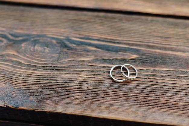 gold rings newlyweds on brown wooden table