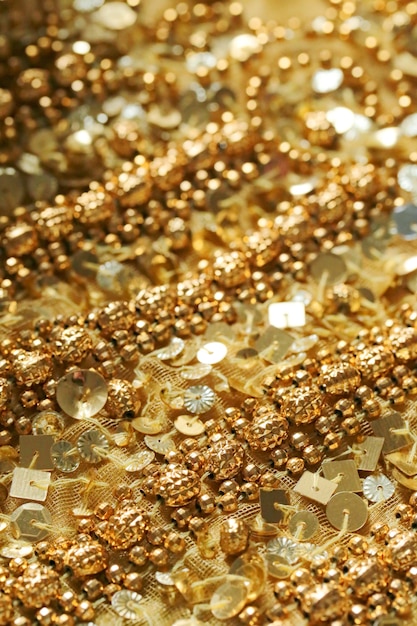 Gold sequins and beads background.  The texture of the fabric with sequins and bugles.