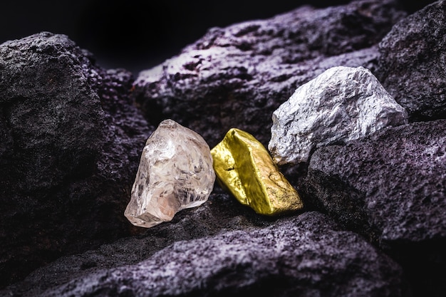 Gold, silver and rough diamond, stones and precious metals in coal mine, concept of myeralogy