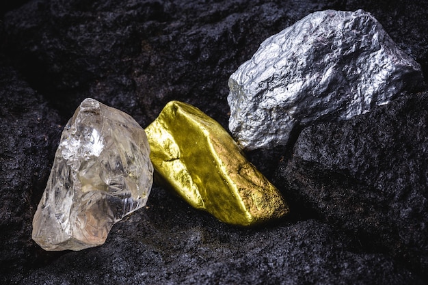 Gold, silver and rough diamond, stones and precious metals in coal mine, concept of myeralogy