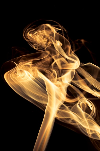 Gold smoke on black background.