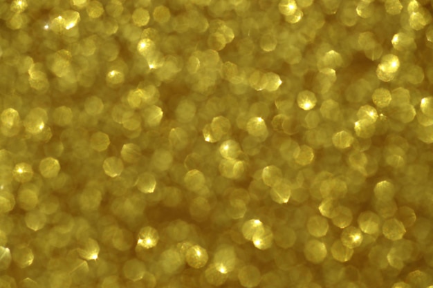 Sfondo sfocato scintilla d'oro con texture glitter e sfocatura