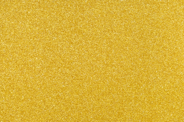 Photo gold sparkling glitter texture background.holiday festive backdrop.