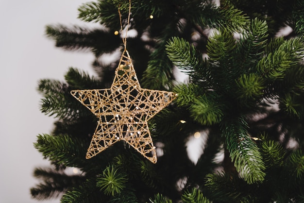 Gold star decoraion on christmas tree