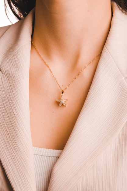 A gold star necklace with a gold star on it.