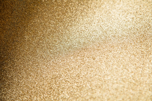 Gold star sparkle party confetti on a gold glitter background