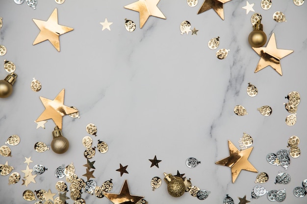 Gold star sparkle party confetti on a marble flat lay background