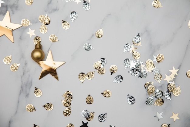 Gold star sparkle party confetti on a marble flat lay background