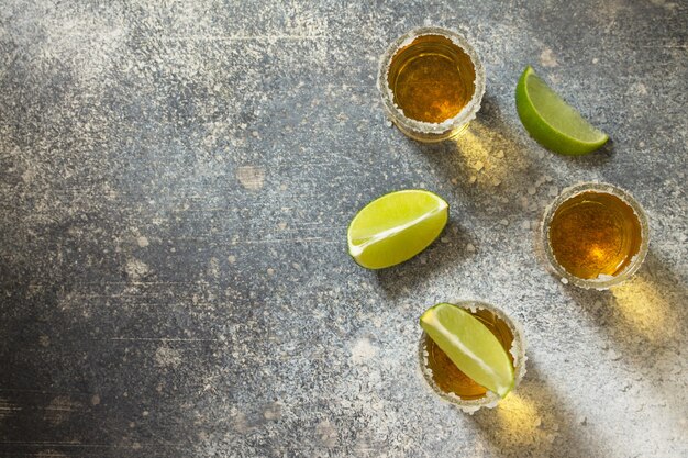 Gold Tequila Mexican Gold Tequila shot with lime and salt Top view Copy space