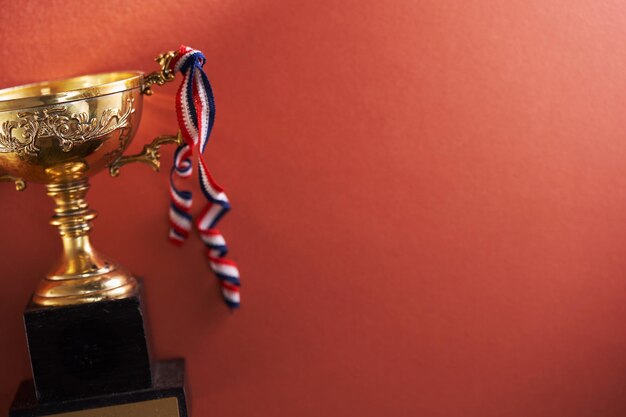 Gold trophy against red background