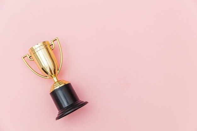 gold trophy cup isolated on blue pastel colorful background