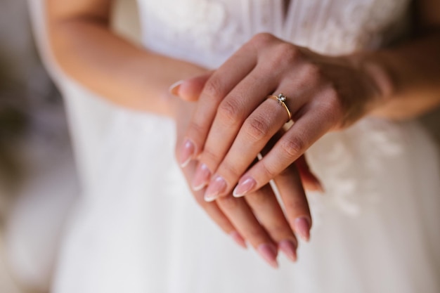 Gold wedding rings are on the bride's hand