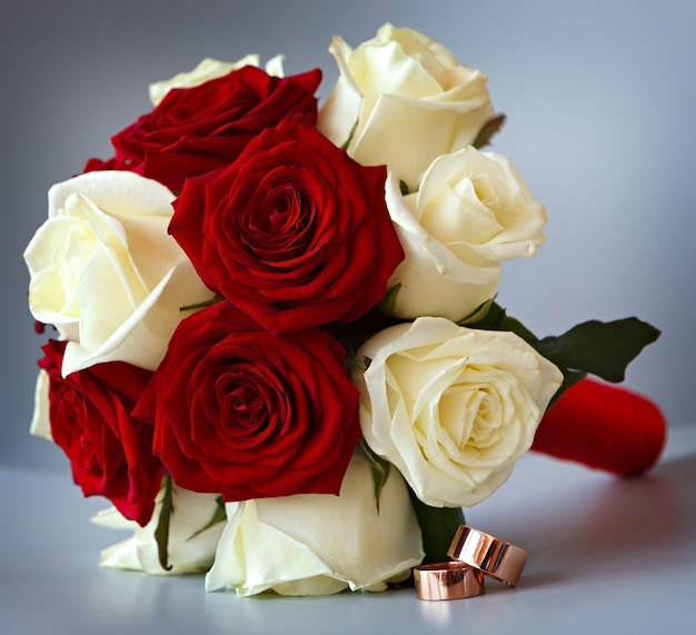 花嫁のための花の花束に金の結婚指輪