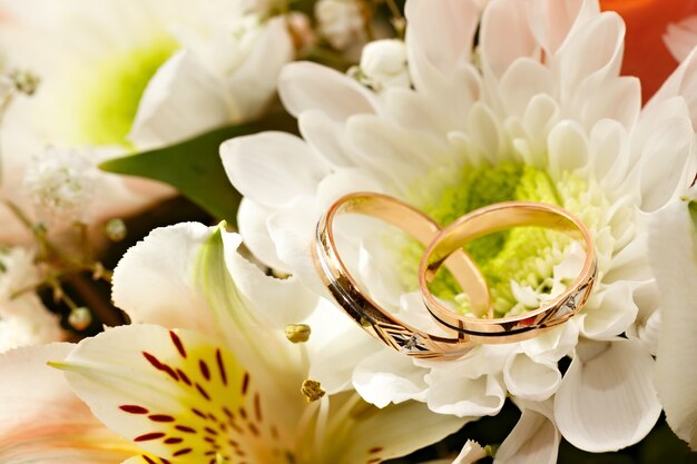 Gold wedding rings on a bouquet of flowers for the bride