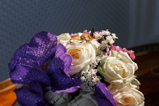 Gold wedding rings on the bride's bouquet. close-up